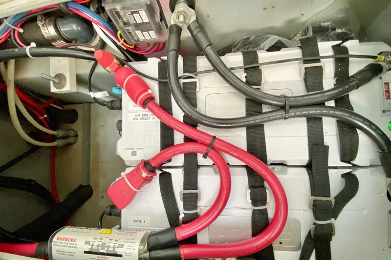Slide: The Image of Battery compartment of a 1998 Manta 40 with cables and connections. - 40