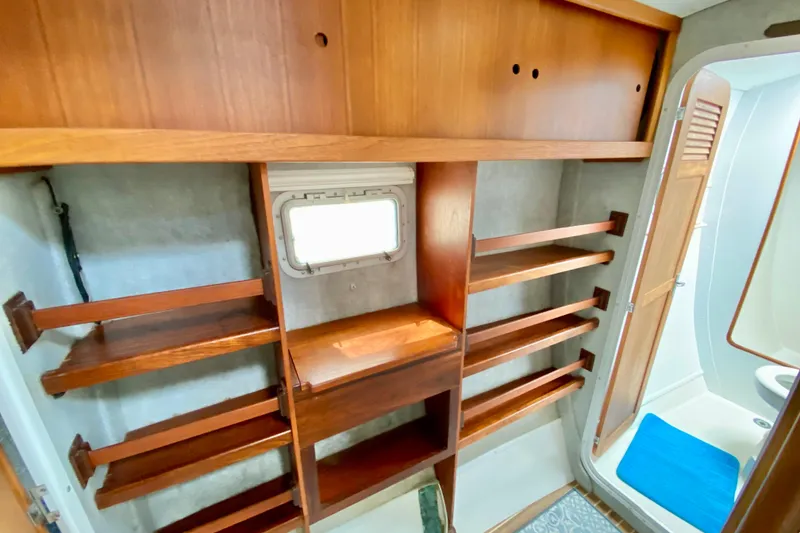 Slide: The Image of 1998 Manta 40 interior with wooden shelving and compact bathroom. - 53