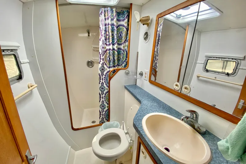 Slide: The Image of Bathroom interior of 1998 Manta 40 yacht with shower, sink, and porthole window. - 55