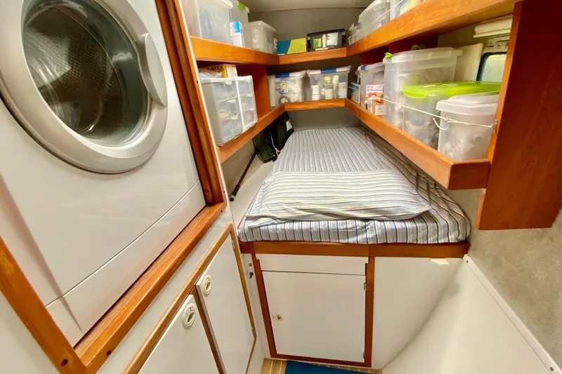 Slide: The Image of Laundry area with storage and a bed in a 1998 Manta 40 yacht. - 67