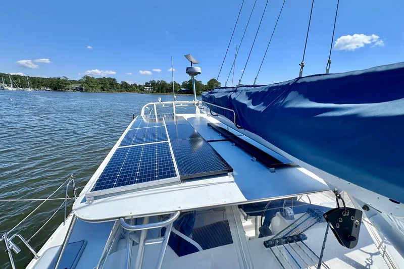 Slide: The Image of Sailboat with solar panels on deck, Manta 40 model, 1998, on a sunny day. - 71