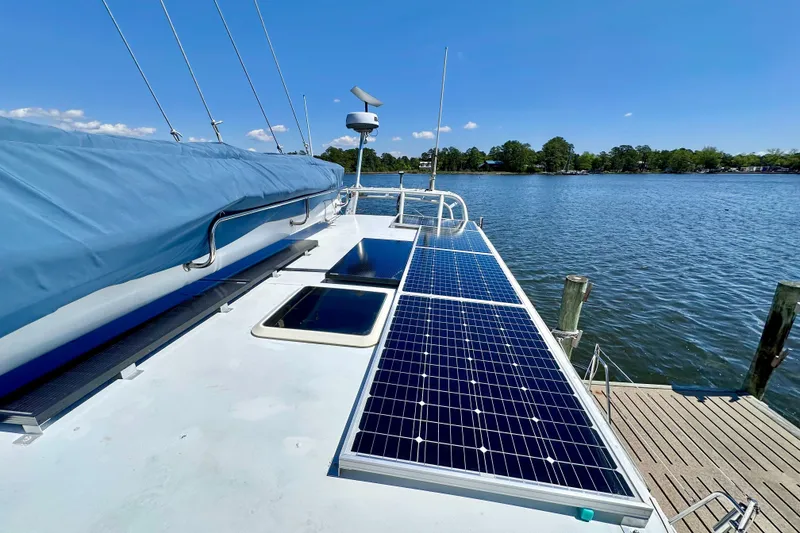 Slide: The Image of Sailboat with solar panels docked on a sunny day, Manta 40, 1998 model. - 72