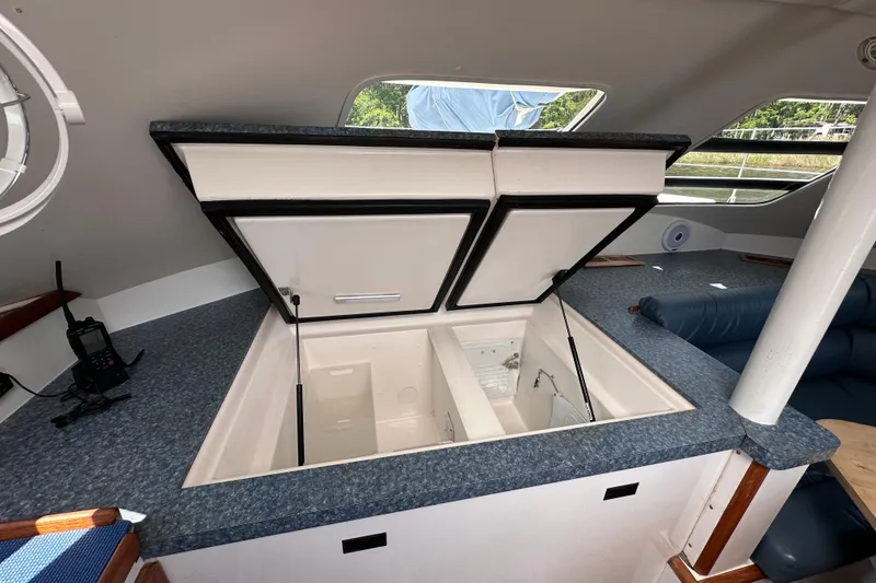 Slide: The Image of Interior of a 1998 Manta 40 yacht featuring an open storage compartment. - 73