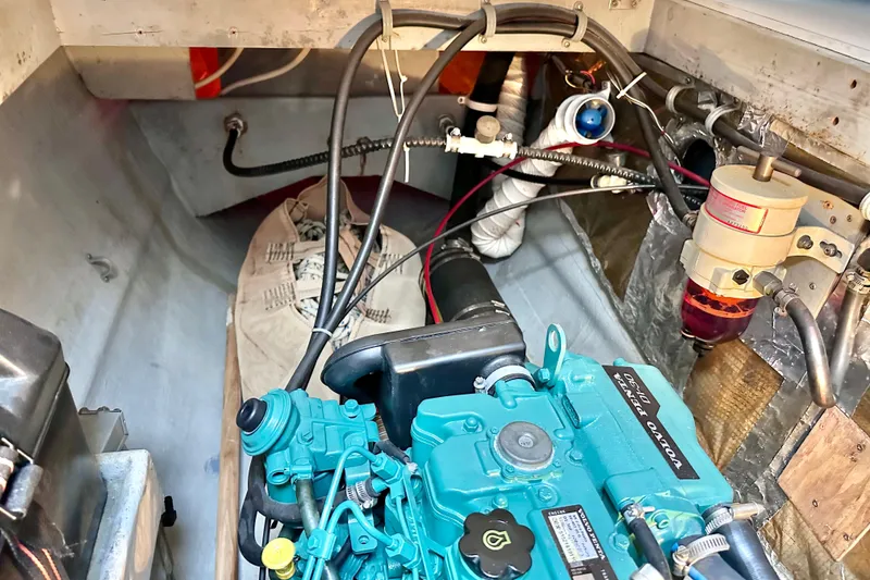 Slide: The Image of Engine compartment of a 1998 Manta 40 boat, featuring a blue diesel engine. - 78