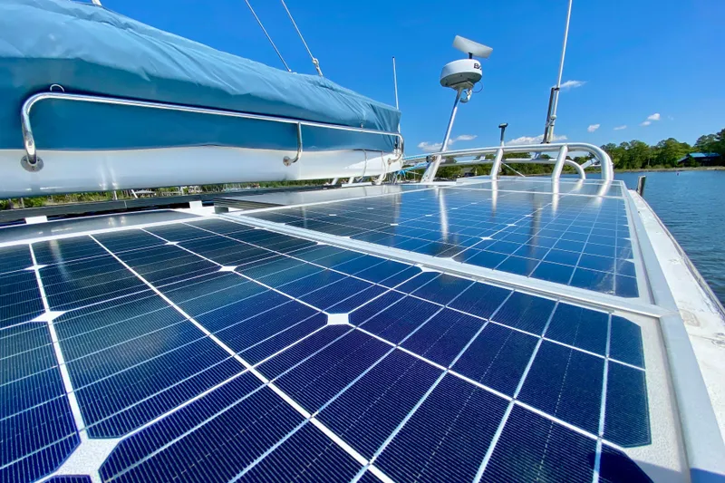 Slide: The Image of Solar panels on a 1998 Manta 40 catamaran under clear blue skies. - 8