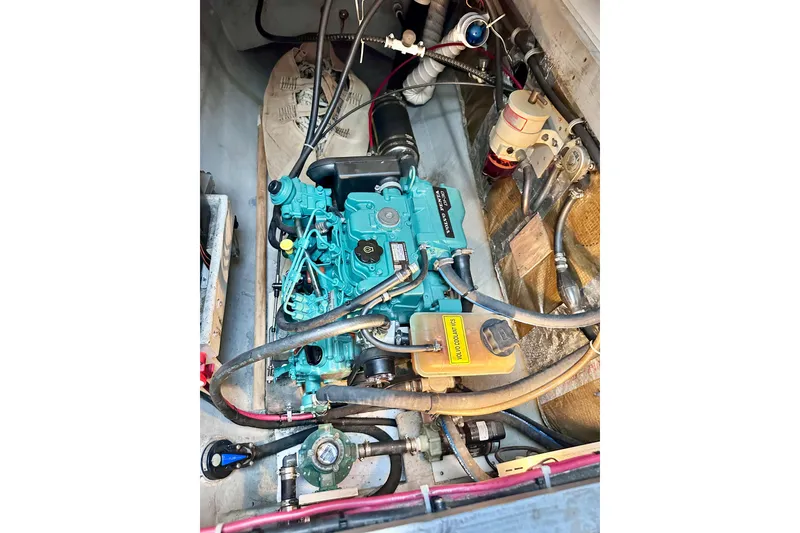 Slide: The Image of Engine compartment of a 1998 Manta 40 sailboat, featuring a well-maintained marine engine. - 80