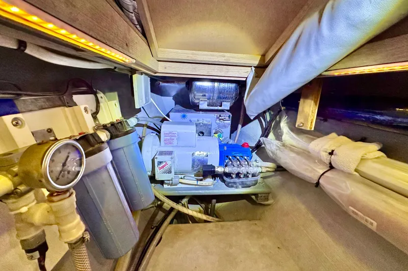 Slide: The Image of Engine room of a 1998 Manta 40 boat, featuring filtration and mechanical systems. - 81