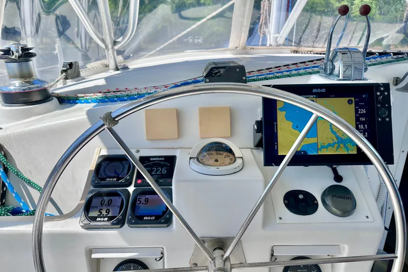 Slide: The Image of Cockpit of 1998 Manta 40 sailboat with navigation instruments and steering wheel. - 87