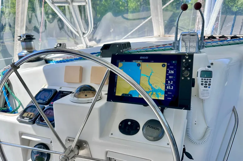 Slide: The Image of Cockpit of 1998 Manta 40 sailboat with navigation equipment and steering wheel. - 89