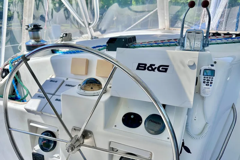 Slide: The Image of Cockpit of 1998 Manta 40 sailboat with steering wheel and navigation equipment. - 91