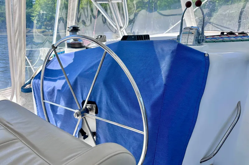 Slide: The Image of Steering wheel of a 1998 Manta 40 sailboat with blue cover and controls. - 92