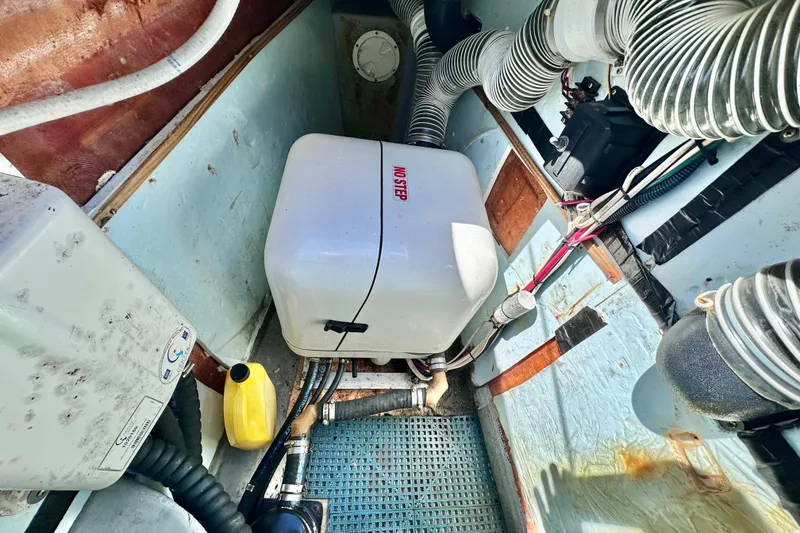 Slide: The Image of Engine compartment of a 1998 Manta 40 boat with various mechanical components. - 98