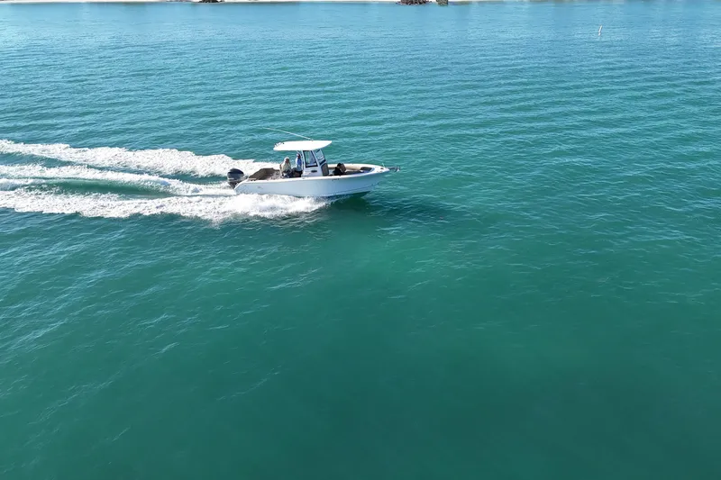 Slide: The Image of 2018 Sea Hunt Ultra 255 SE cruising on clear blue water. - 4