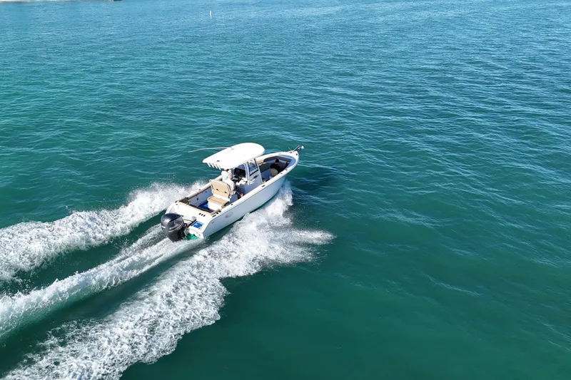 Slide: The Image of 2018 Sea Hunt Ultra 255 SE cruising on clear blue ocean waters. - 6