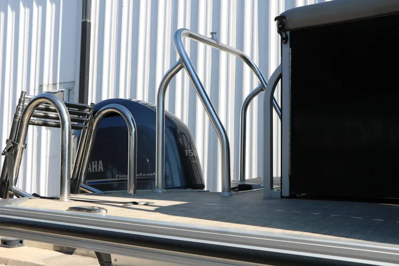 Slide: The Image of 2020 Silver Wave 2210 SW5 L boat with Yamaha engine, docked near a metal building. - 18