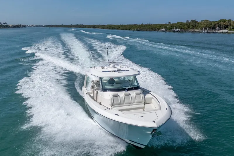 The Image of 2024 Tiara Yachts 43 LS cruising on clear blue water, leaving a wake behind. - 0