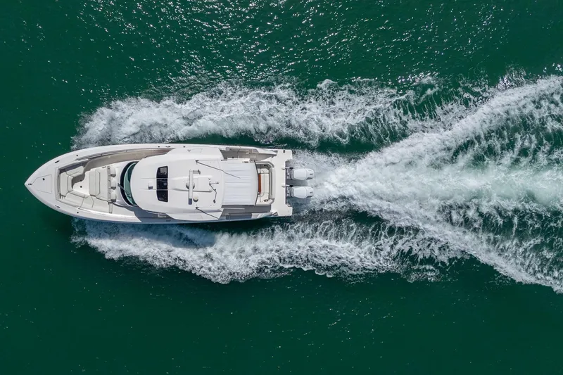 Slide: The Image of 2024 Tiara Yachts 43 LS cruising on open water, aerial view. - 10