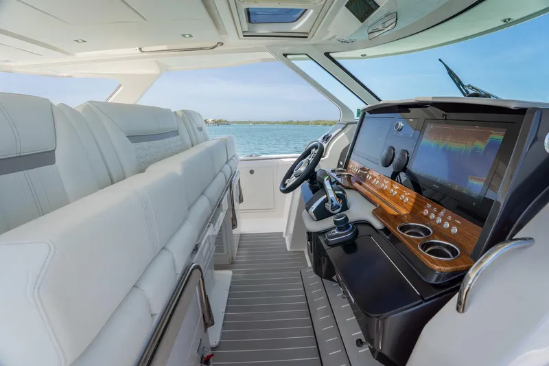 Slide: The Image of 2024 Tiara Yachts 43 LS helm with modern controls and luxurious seating. - 12