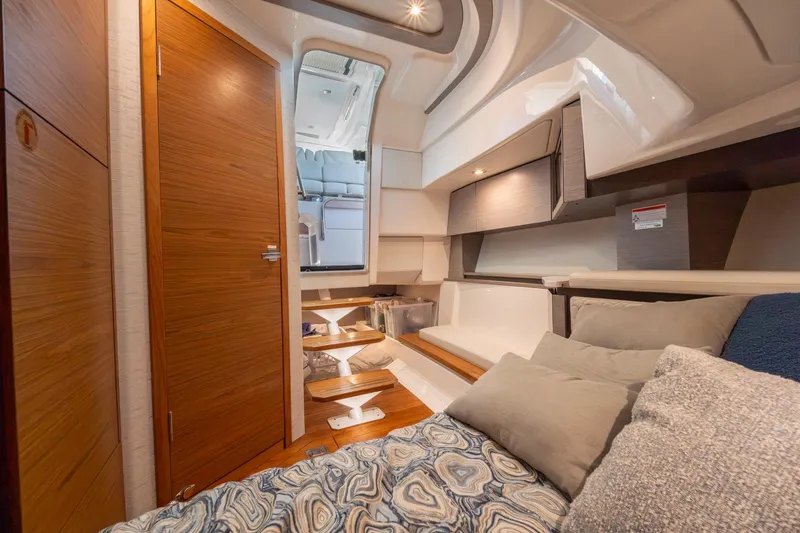 Slide: The Image of Luxurious interior of 2024 Tiara Yachts 43 LS, featuring cozy seating and elegant wood finishes. - 13