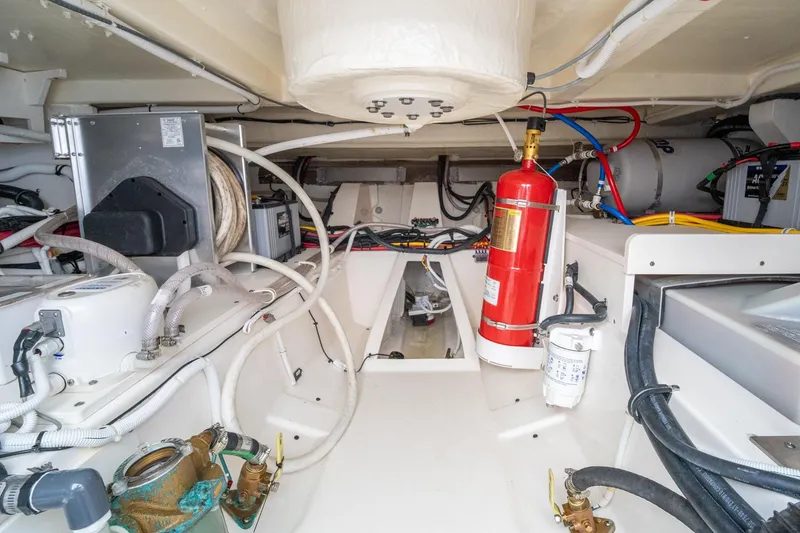 Slide: The Image of Engine room of 2024 Tiara Yachts 43 LS, featuring fire extinguisher and complex wiring. - 14