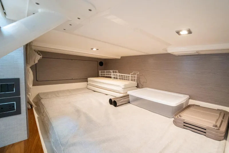 Slide: The Image of 2024 Tiara Yachts 43 LS cabin interior with storage and bedding. - 15