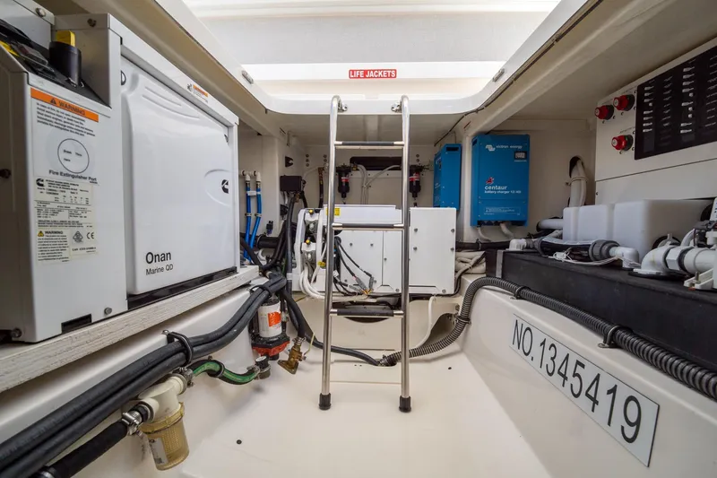 Slide: The Image of Engine room of 2024 Tiara Yachts 43 LS, featuring Onan Marine QD generator and equipment. - 17