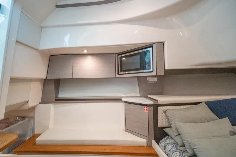 Slide: The Image of 2024 Tiara Yachts 43 LS interior with modern cabinetry and cozy seating area. - 19