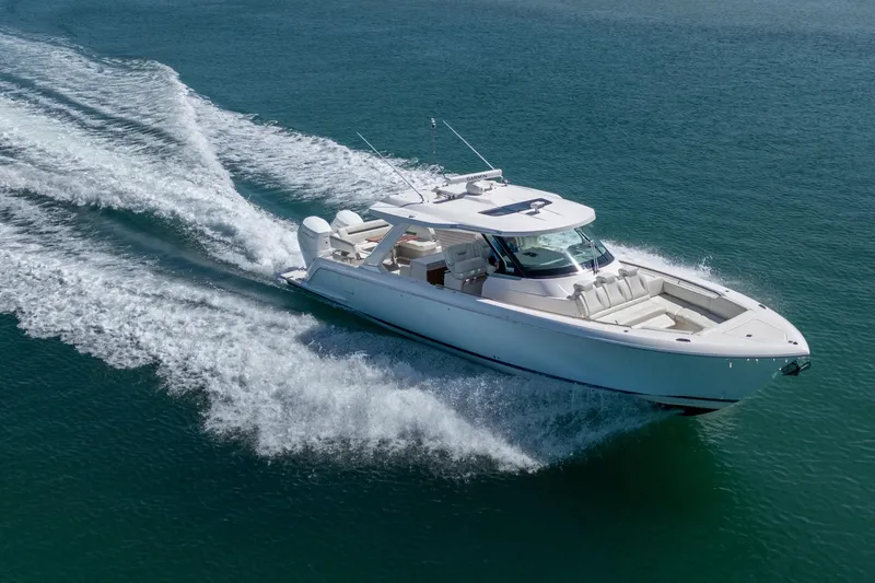 Slide: The Image of 2024 Tiara Yachts 43 LS cruising on open water, showcasing sleek design and powerful performance. - 2