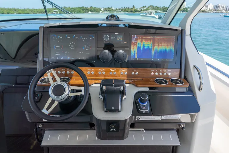 Slide: The Image of 2024 Tiara Yachts 43 LS helm with advanced navigation displays and controls. - 22