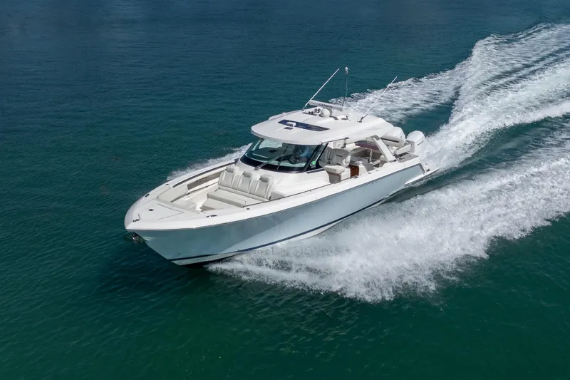 Slide: The Image of 2024 Tiara Yachts 43 LS cruising on clear blue water, showcasing sleek design and performance. - 4