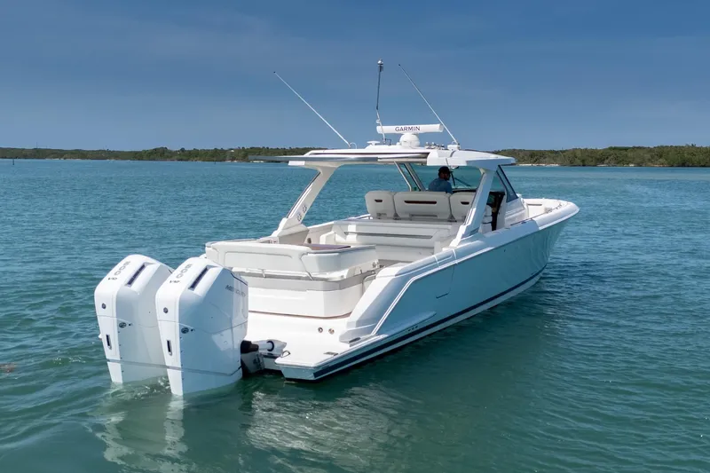 Slide: The Image of 2024 Tiara Yachts 43 LS cruising on clear blue water. - 5