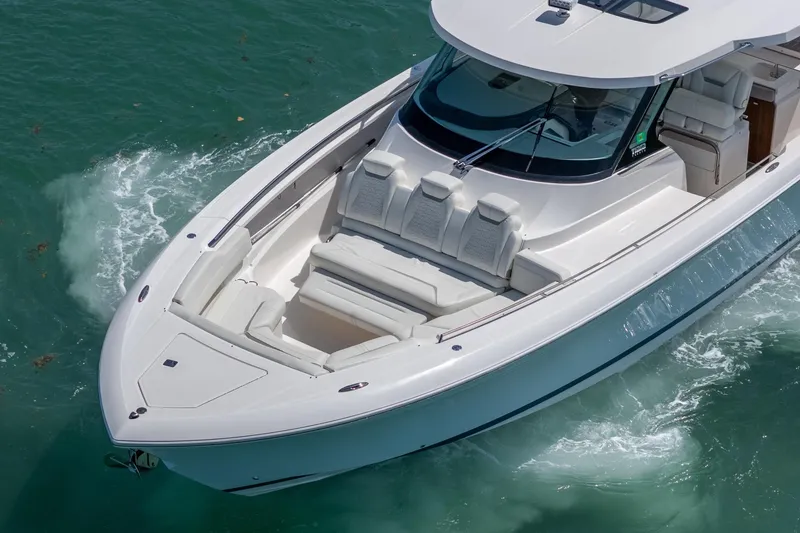 Slide: The Image of 2024 Tiara Yachts 43 LS cruising on turquoise waters, showcasing sleek design and luxury seating. - 6