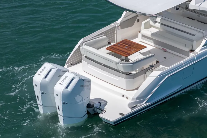 Slide: The Image of 2024 Tiara Yachts 43 LS with dual Mercury outboard engines, featuring a spacious deck and seating area. - 7