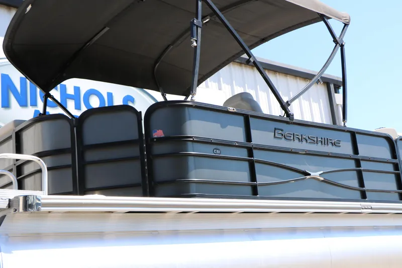 Slide: The Image of 2019 Berkshire 22CL CTS pontoon boat with canopy, docked near a building. - 17