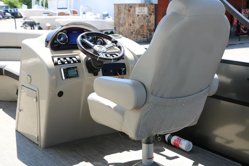 Slide: The Image of Captain's chair and helm of a 2019 Berkshire 22CL CTS pontoon boat. - 26