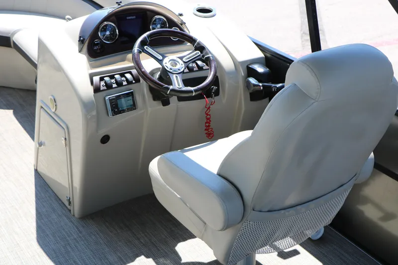 Slide: The Image of 2019 Berkshire 22CL CTS boat helm with steering wheel and control panel. - 29