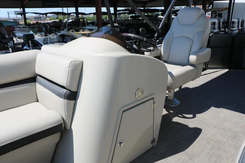 Slide: The Image of 2019 Berkshire 22CL CTS boat interior with beige seating and steering console. - 41