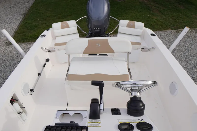 Slide: The Image of 2015 Edgewater 170CC boat interior with steering wheel and seating. - 13