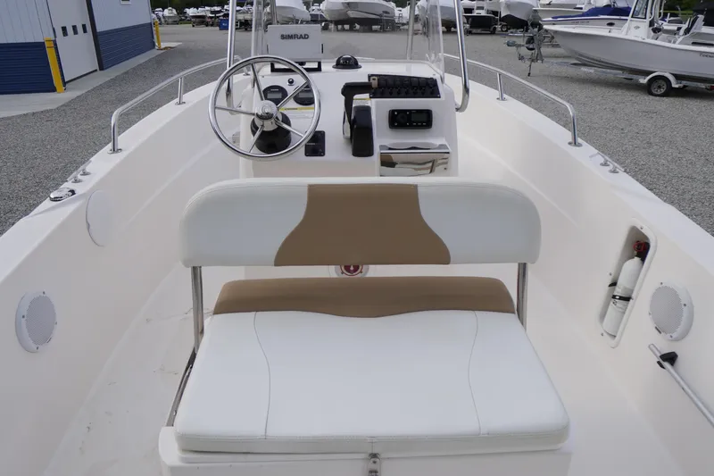 Slide: The Image of 2015 Edgewater 170CC boat interior with steering wheel and seating. - 14