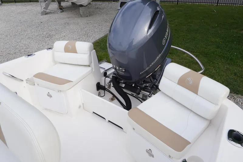 Slide: The Image of 2015 Edgewater 170CC boat interior with Yamaha outboard motor and cushioned seating. - 15