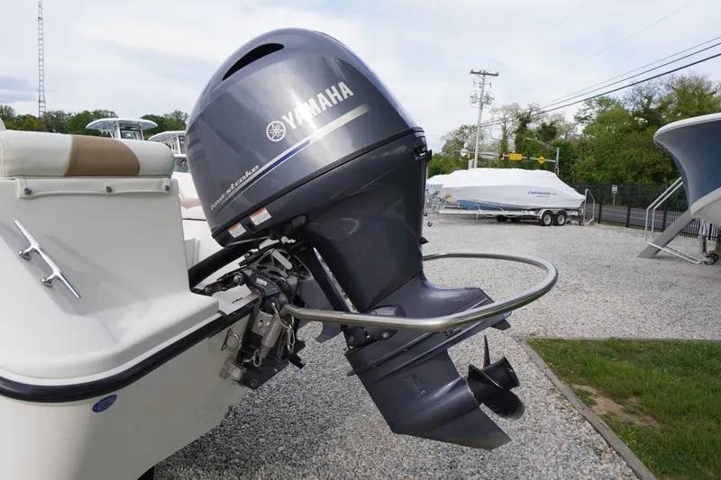 Slide: The Image of 2015 Edgewater 170CC boat with Yamaha outboard motor in a gravel lot. - 16