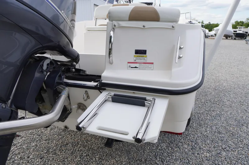 Slide: The Image of 2015 Edgewater 170CC boat with motor and swim platform on gravel surface. - 18