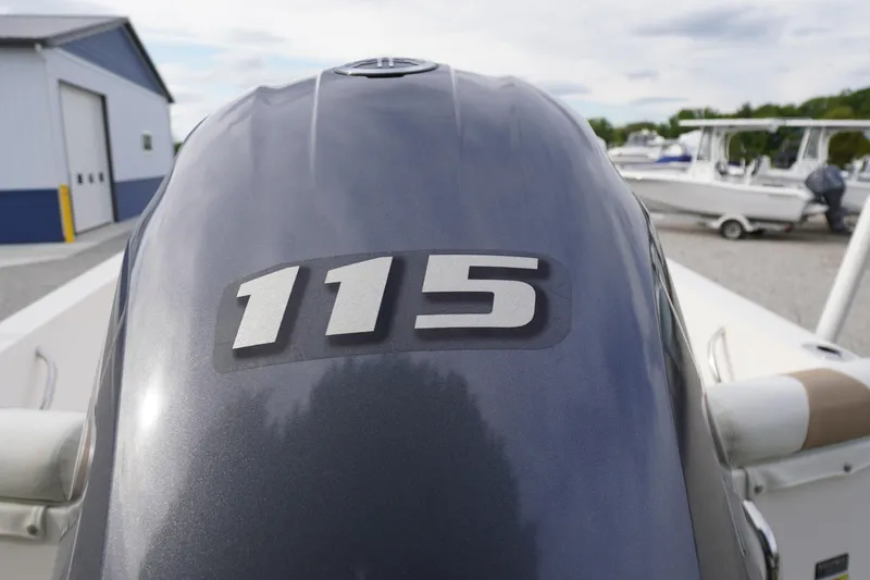 Slide: The Image of Outboard motor with "115" label on a 2015 Edgewater 170CC boat. - 19
