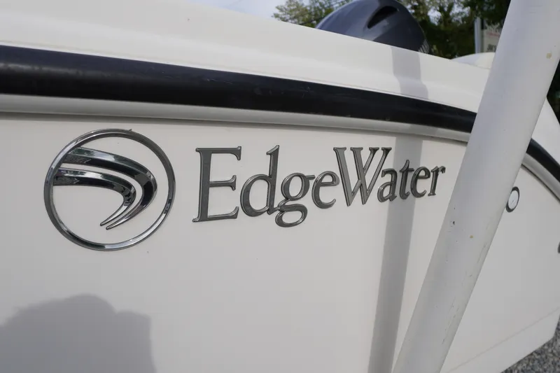 Slide: The Image of 2015 Edgewater 170CC boat logo on white hull, close-up view. - 2