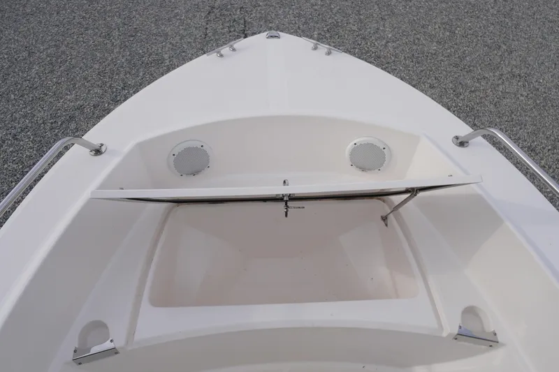 Slide: The Image of Bow view of 2015 Edgewater 170CC boat with open storage compartment and speakers. - 5