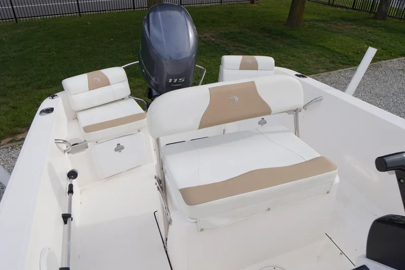 Slide: The Image of 2015 Edgewater 170CC boat interior with Yamaha 115 engine, featuring white and beige seating. - 7