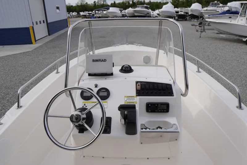 Slide: The Image of 2015 Edgewater 170CC boat dashboard with steering wheel and navigation equipment. - 8