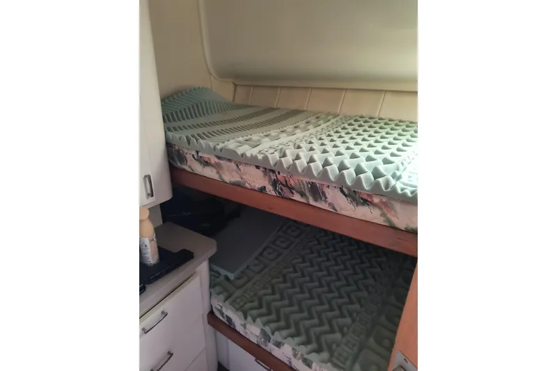 Slide: The Image of Bunk beds with foam mattresses in a 1996 Mainship 40 Sedan Bridge cabin. - 14