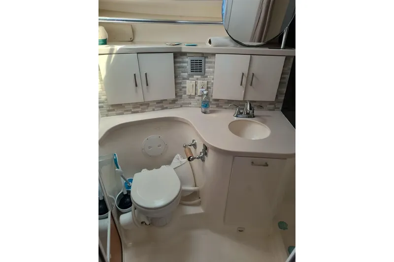 Slide: The Image of Bathroom interior of 1996 Mainship 40 Sedan Bridge yacht, featuring sink and toilet. - 15