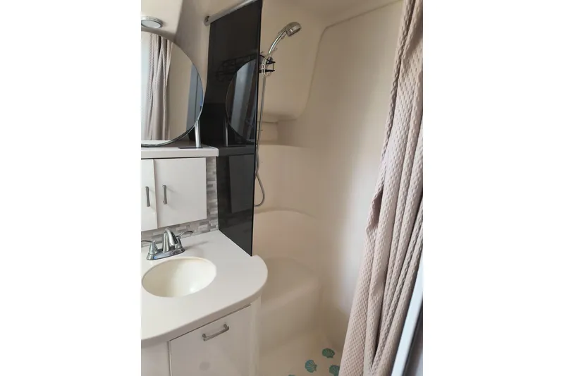 Slide: The Image of Bathroom interior of 1996 Mainship 40 Sedan Bridge with shower and vanity. - 16